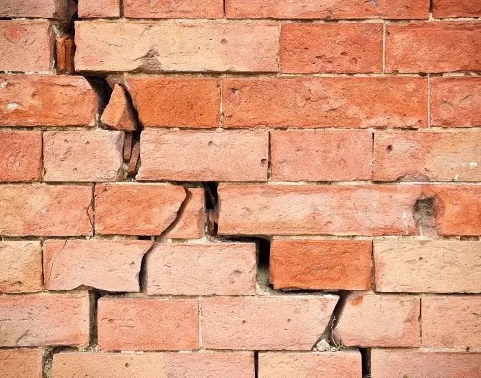 A brick wall with cracks in it from foundation issues in Fort Atkinson, WI