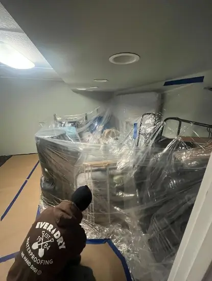 Workers prepping the basement for waterproofing in Franklin, WI